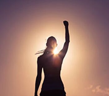 A woman raises her fist in the air.